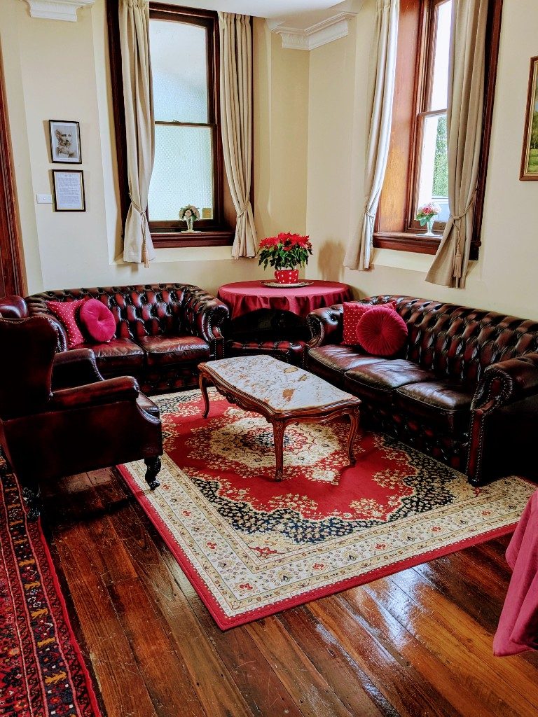 Downstairs lounge with leather sofas and oriental rug