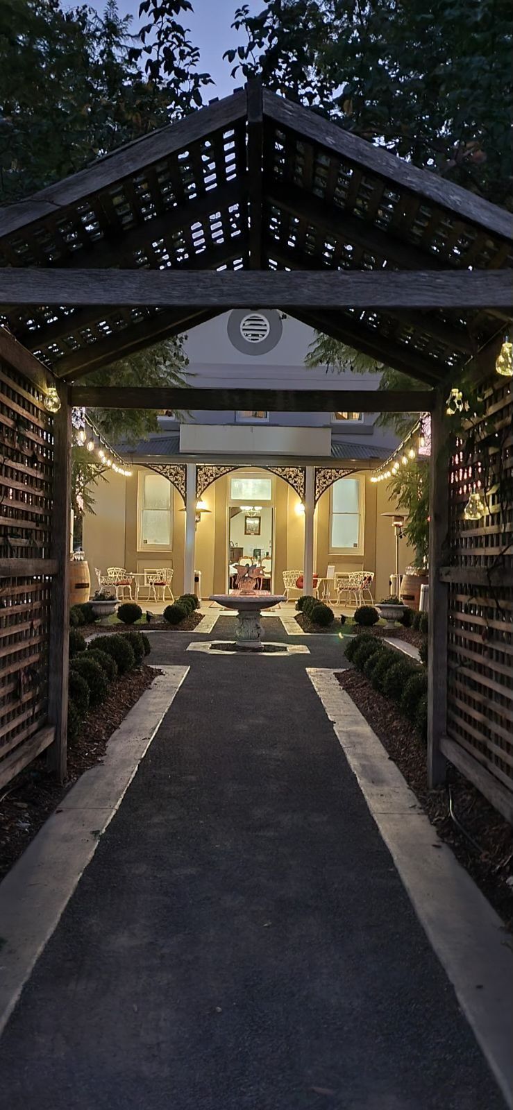 Garden path and fountain at dusk, looking toward the Courthouse